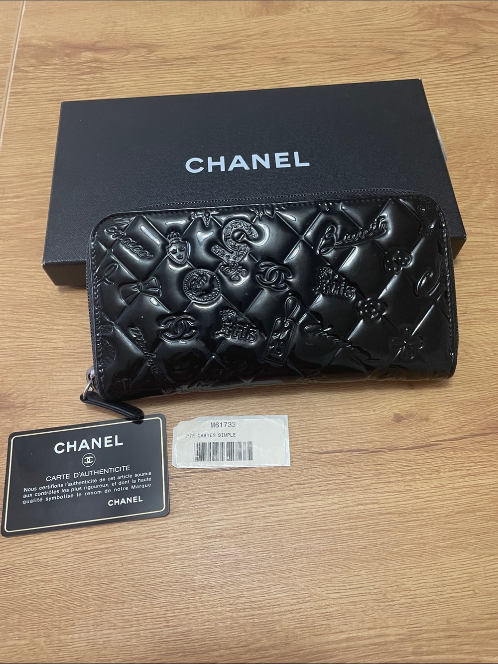 CHANEL Black Quilted Patent Leather Zip-Around Wallet with Embossed Motifs